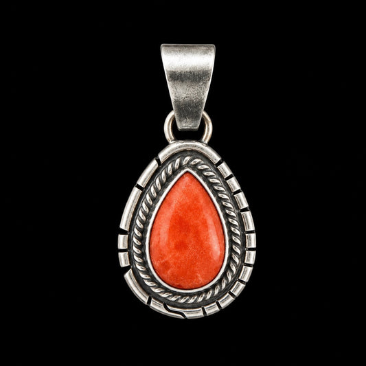 Silver pendant with a red spiny oyster stone on a black background