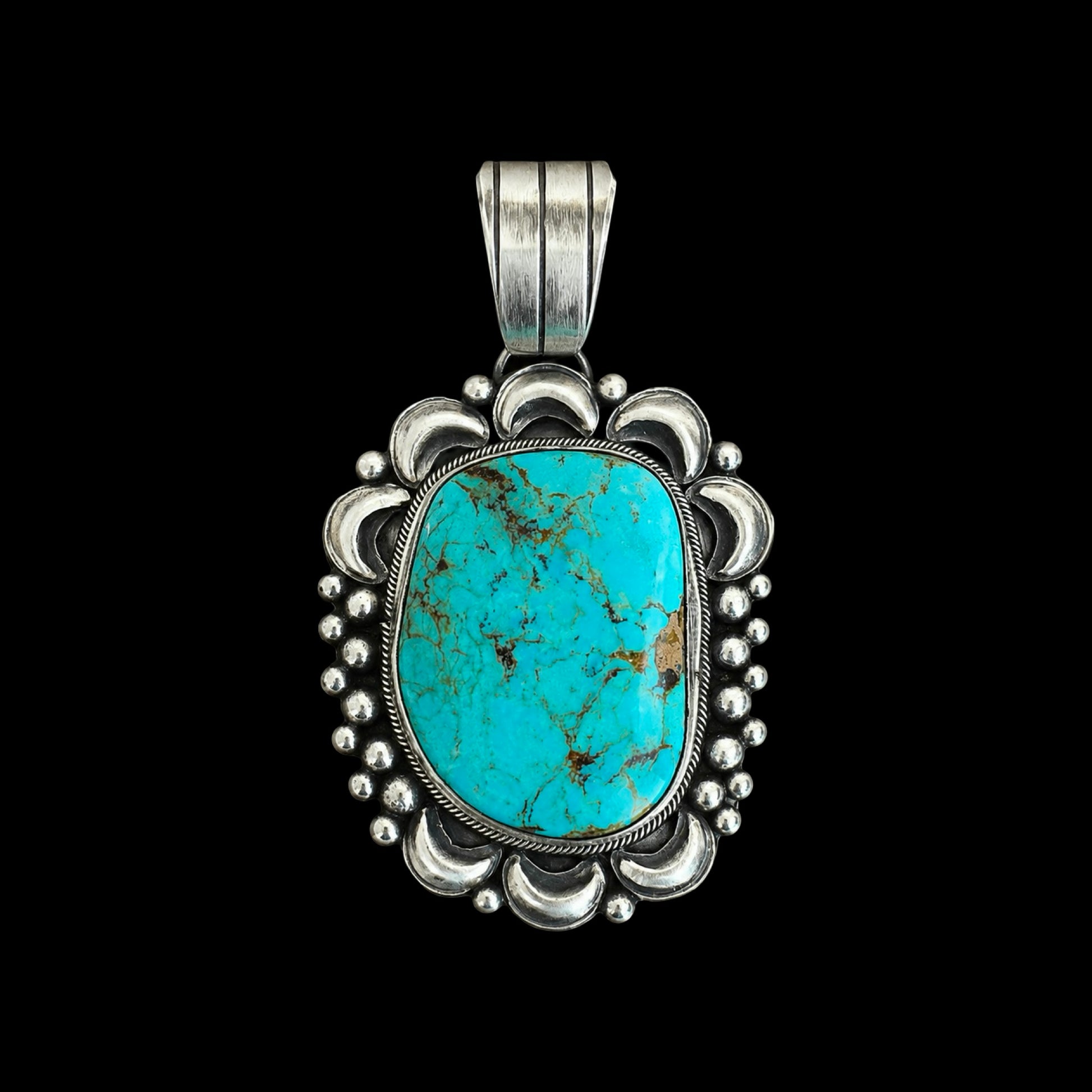 Turquoise pendant with silver frame on black background