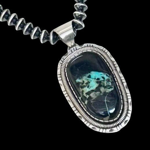 Blackjack Turquoise pendant handcrafted by Native American artist Walter Vandever