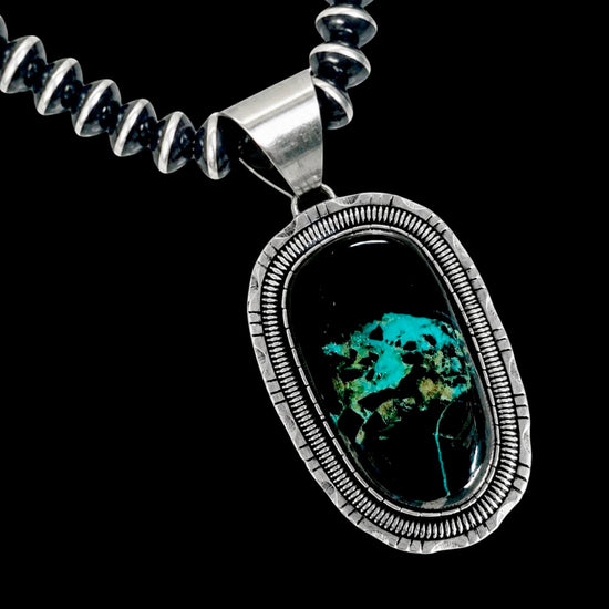Necklace with a silver pendant featuring blackjack stone on a black background
