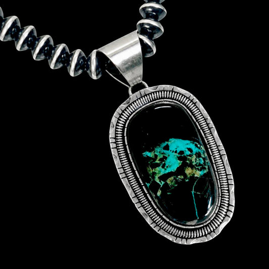 Necklace with a silver pendant featuring blackjack stone on a black background