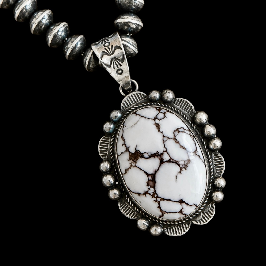 Necklace with a wild horse stone pendant on a black background by Donovan Nez