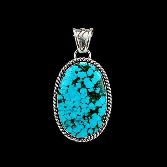 Turquoise pendant necklace on a black background by Sheena Jack