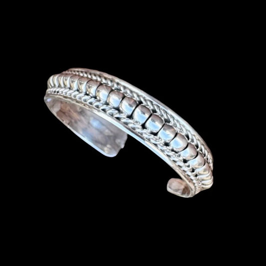 Rolled Sterling Silver cuff handcrafted by Native American artist Manvel Johnson