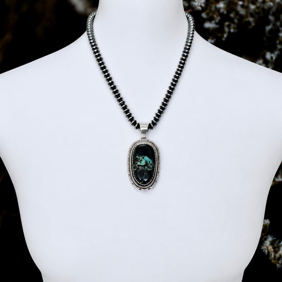 Blackjack Turquoise pendant handcrafted by Native American artist Walter Vandever
