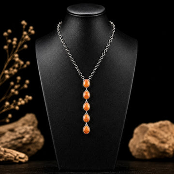 Orange Spiny Oyster lariat handcrafted by Native American artist Delaine & Dwayne Nez