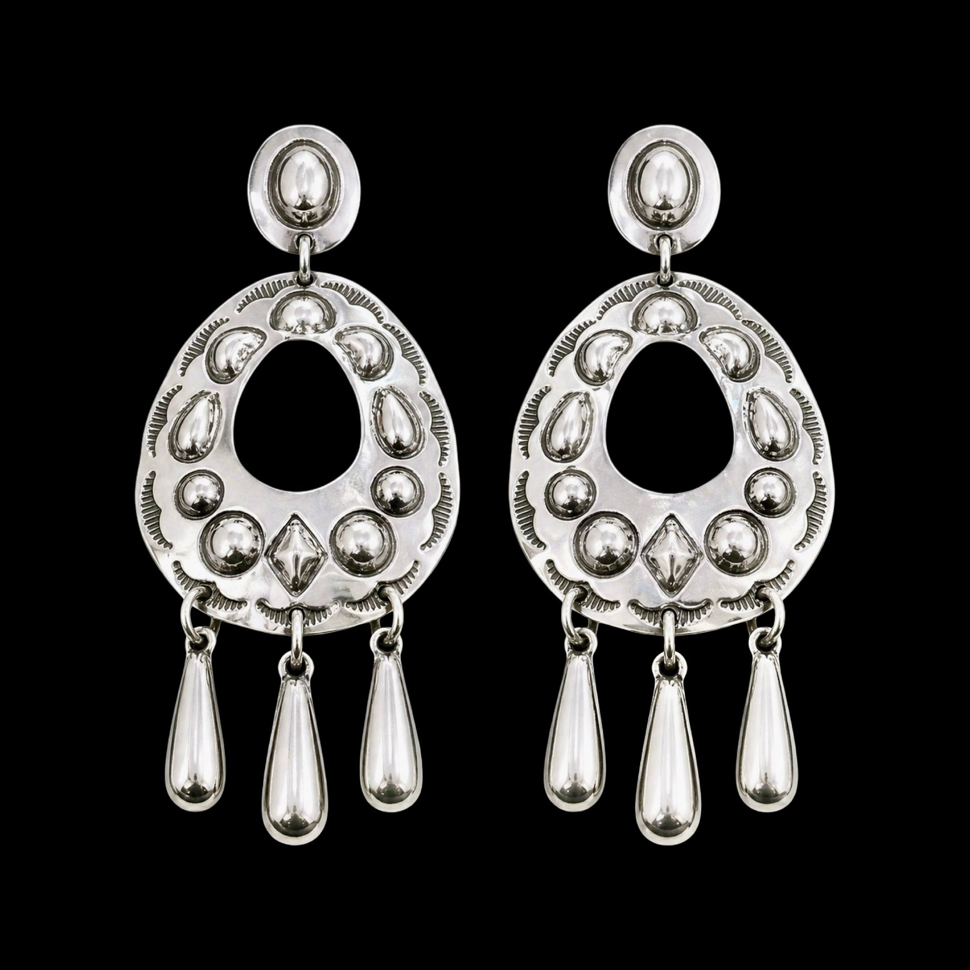 Sterling Silver Repoussé earrings handcrafted by Native American artist Tim Yazzie