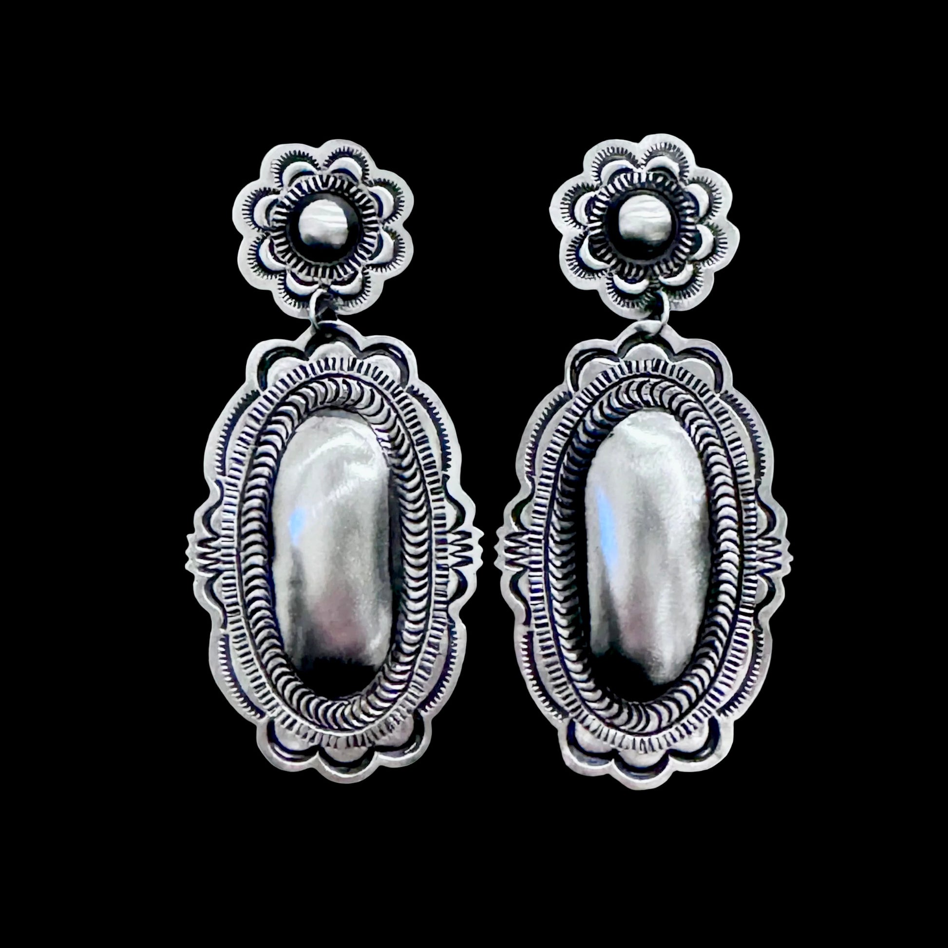 Sterling Silver Repoussé earrings handcrafted by Native American artist Leander Tahe